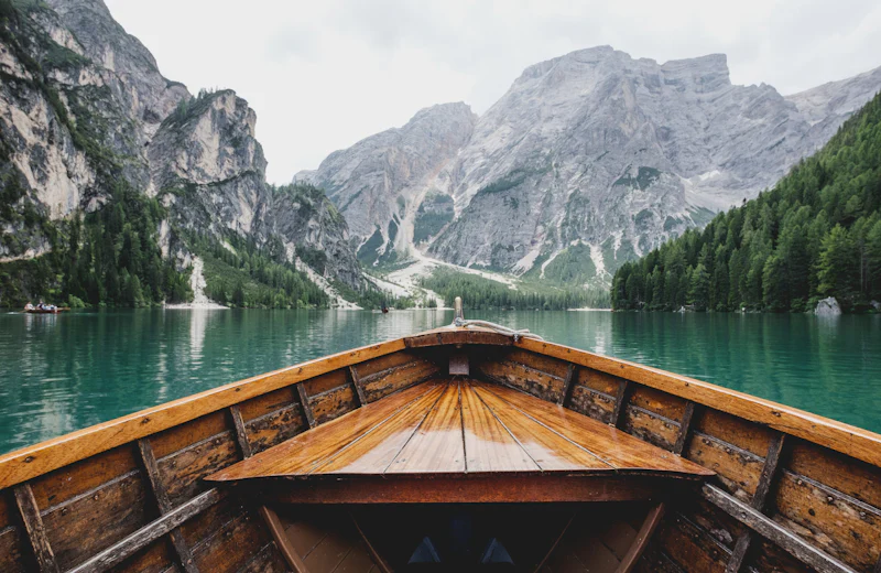 Wooden boat on a clear mountain lake